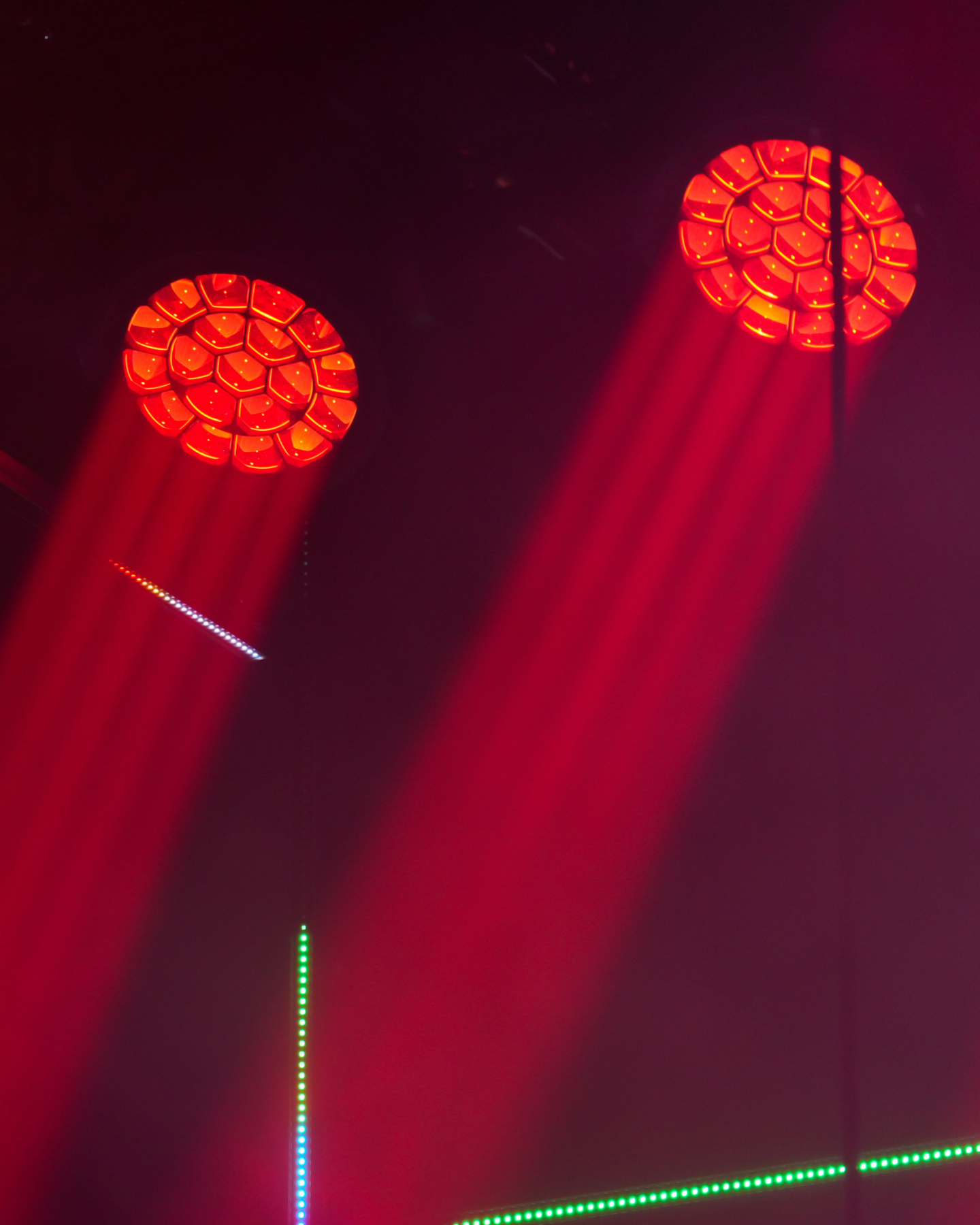 Proiettori LED rossi in funzione con fasci di luce per allestimenti scenici ed eventi live